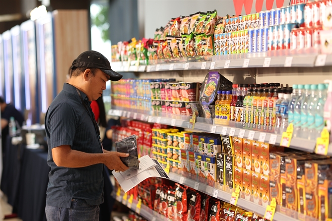 A customer selects Masan Consumer products at a WinMart supermarket.